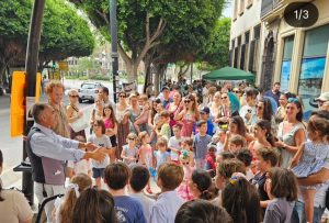 Niños participando en un truco de magia durante la feria